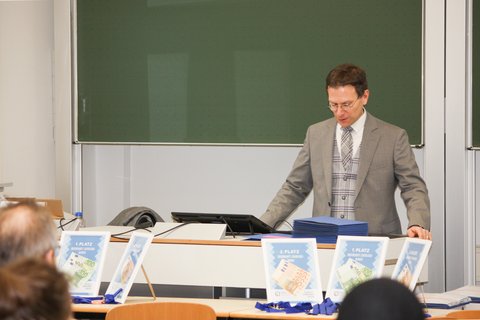 Prof. Dr. Henning Zindler bei der Preisverleihung präsentiert vor den Schüler*innen. (öffnet Vergrößerung des Bildes)