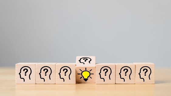 Concept creative idea and innovation. Wooden cube block flip over with head human symbol and light bulb icon