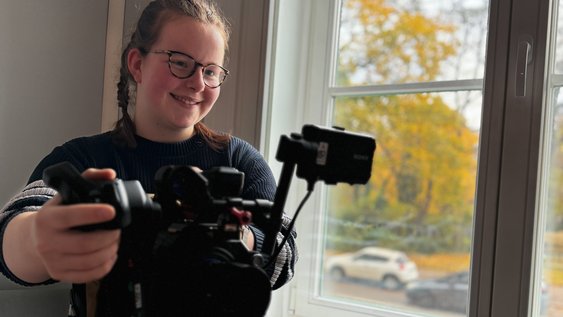 Merle Gerdawischke steht an einer Filmkamera