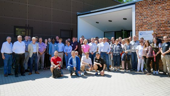 Teilnehmende und Referenten des Projekttags Wasser posieren für ein Gruppenfoto vor dem Eingang des INBW