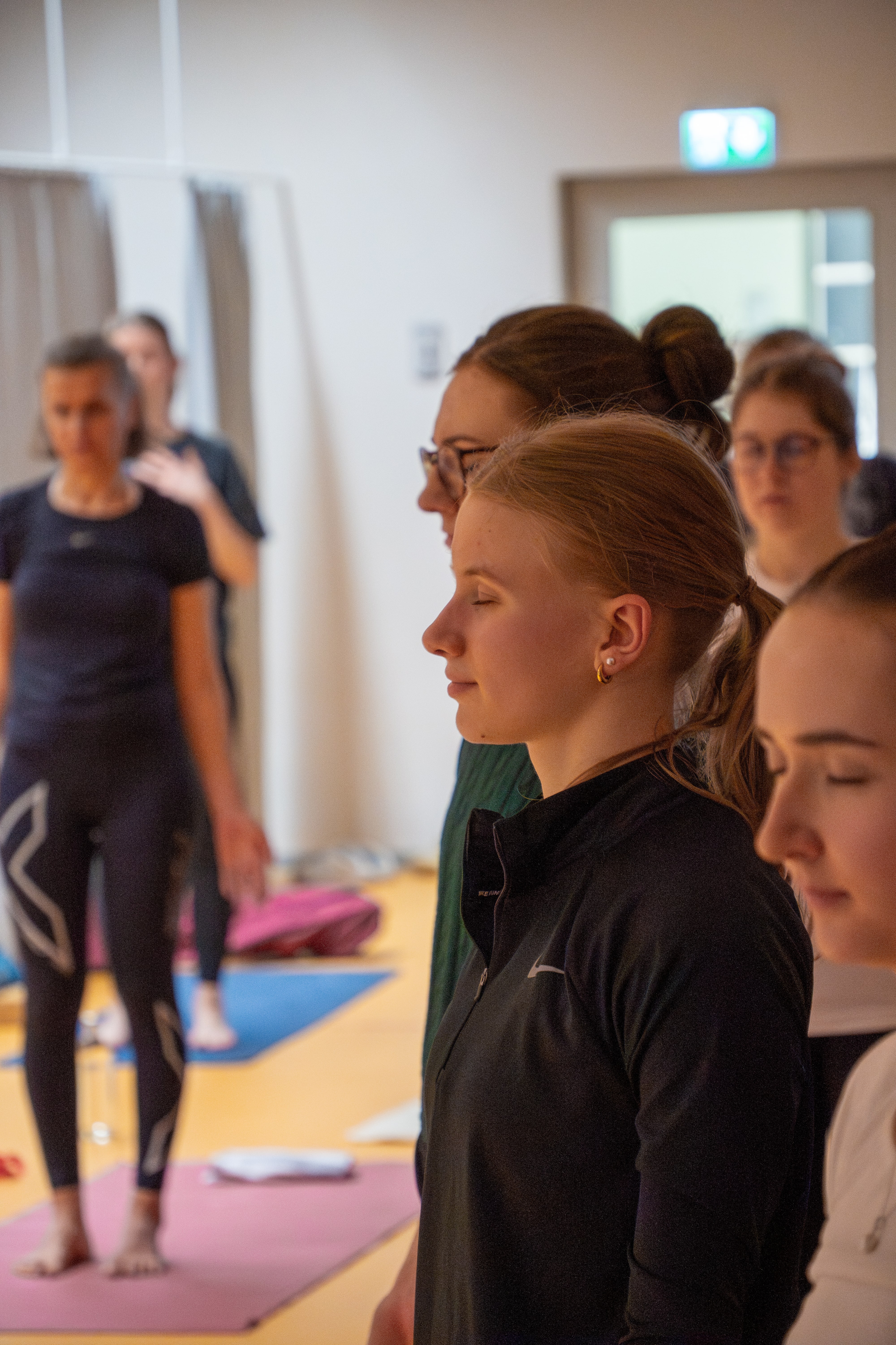 Yoga-Teilnehmende im Gymnastikraum der Ostfalia Hochschule bei einer entspannten Atemübung.